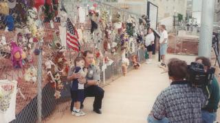 Kevin pictured with son at memorial fence years after blast