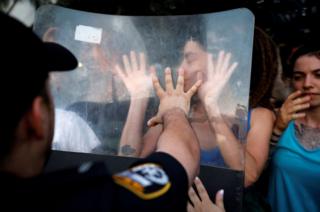 Protesters scuffle with police during a protest
