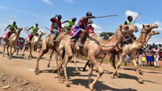 Participants attend a professional camel race during the 29th edition of the Maralal International Camel Derby at Maralal, Samburu County, Northern Kenya on September 2, 2018. -