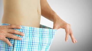 Man checking what's in his boxer shorts