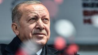 Turkish President Recep Tayyip Erdogan greets his supporters after his speech during a pre-election rally at Bayrampasa district in Istanbul