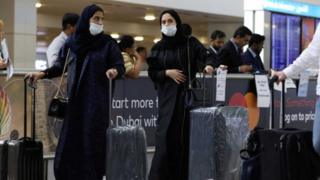 سيدتان ترتديان أقنعة طبية في أحد المطارات العربية