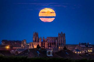The Supermoon rises above Whitby Abbey in Yorkshire