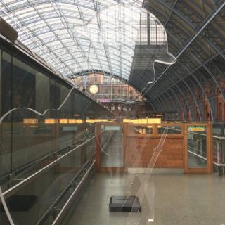 The installation of three 'There But Not There' Tommies at St Pancras Station in London