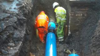 Engineers repairing the pipe