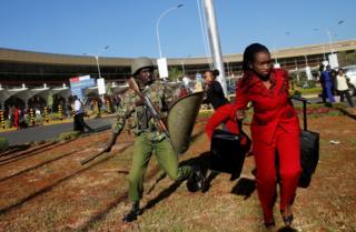 Kenya Airways workers are dispersed by riot police officers