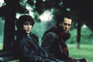 Paul McGann (left) and Richard E Grant on a park bench in the film Withnail and I