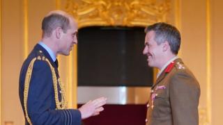Prince William makes Brigadier Tobias Lambert an Officer of the Order of the British Empire.