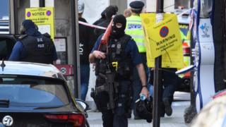 Armed police return to their vehicles following an attack near London Bridge station, 4 June 2017