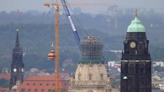 A crane lifts a cupola on top of Dresden cathedral in 2004
