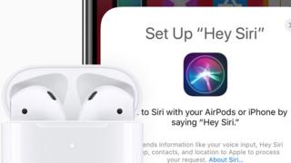The new AirPods with Siri support shown in front of an iPhone screen