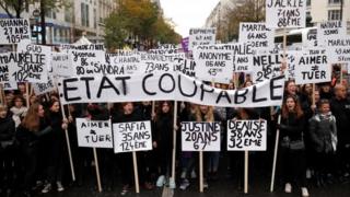 Protesters in Paris hold slogans that read: "The state is guilty". Photo: 23 November 2019
