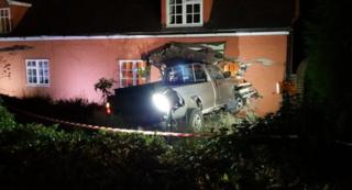 Silver Mitsubishi embedded in cottage wall