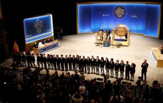 Children from San Ildefonso school pose moments before the start of "El Gordo" Christmas lottery draw at the Royal Theater in Madrid