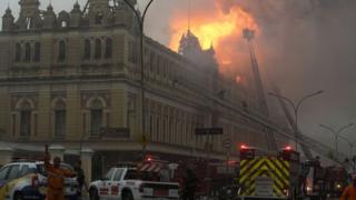 Fire-fighters work to douse the flames at the Portuguese Language Museum in Sao Paulo, Brazil, Monday, Dec. 21, 2015