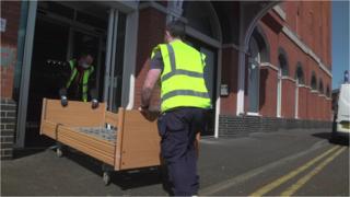 Workers bringing equipment into the Ramada hotel as part of its transformation