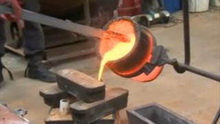 Molten metal being poured into a mould