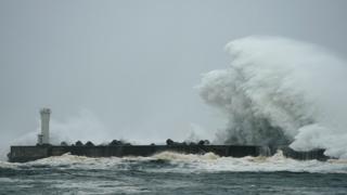 Surging waves generated by Typhoon Hagibis hit against a breakwater at a port in the town of Kiho, Mie Prefecture, Japan, 12 October 2019