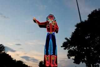 A neon sign of a cowboy