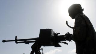 File photo: A Somali soldier holds a machine gun during a patrol in the streets of Merka, 90kms north of Mogadishu, on September 2, 2012.