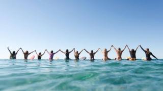 Group of women surfers