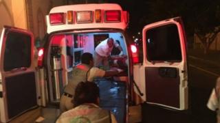 Paramedics treat a victim after a shooting in a rehabilitation center in Chihuahua, Mexico, 27 September 2017.