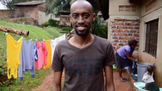 Yoza Co-founder, Nicholas Kamanzi with cleaner Naiga in the background
