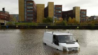 An abandoned van is pictured in flood water near residential buildings in Rotherham, northern England on November 8, 2019, following flash flooding