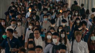 A crowd wearing surgical masks in China