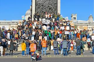 Protesters gather on the steps of Nelson's Column in Trafalgar Square