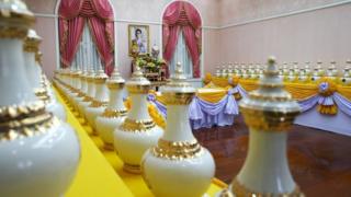 A picture of Thailand's King Maha Vajiralongkorn is seen among ewers containing sacred water for his upcoming coronation ceremony at the Interior Ministry in Bangkok, Thailand, April 10, 2019.