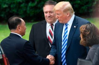 US President Donald Trump (C-R), flanked by US Secretary of State Mike Pompeo shakes hands with North Korean Kim Yong Chol