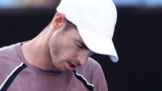 Andy Murray hangs his head during an Australian Open match