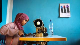 Woman sews.