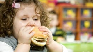 Ребенок ест гамбургер