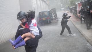 A policeman rescues a small girl in Hong Kong