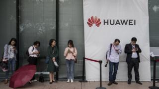 Huawei staff look at mobile firms at firm's campus in Shenzhen, China, 12 April 2019