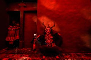 A reveller depicting the devil performs at a church in Bogota, Colombia, on 12 December 2019