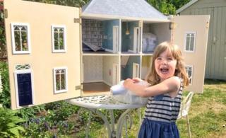 Girl with dolls' house