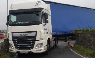 Lorry wedged on bridge