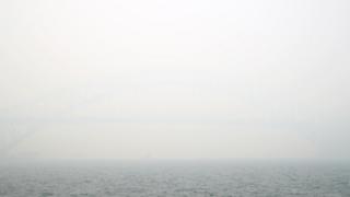 Sydney Harbour Bridge obscured by grey smoke