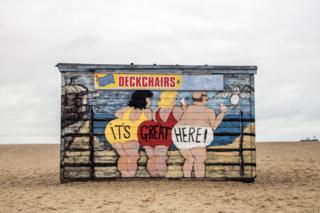 A colourfully decorated hut on the beach in Great Yarmouth