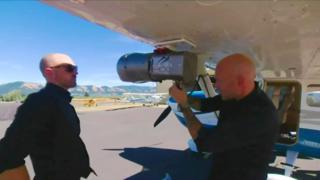 Two men inspecting a device