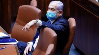 Israeli Prime Minister Benjamin Netanyahu wears a mask before a swearing in ceremony of a unity government in parliament in Jerusalem. Photo: 17 May 2020
