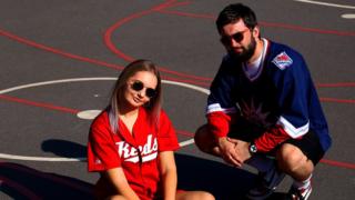 Kieran and his girlfriend Alannah pose in vintage sportswear to promote his vintage shop