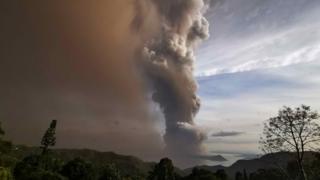 An ash column from Taal volcano looms over Tagaytay city, Philippines, 12 January 2020.