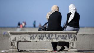 Two women sitting on a bench in Alexandria, Egypt