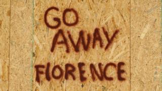 A message is posted on a boarded up building before the arrival of Hurricane Florence on Oak Island, North Carolina