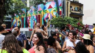 Revellers dance in the streets