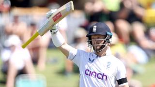 England opener Ben Duckett raises his bat after reaching his fifty